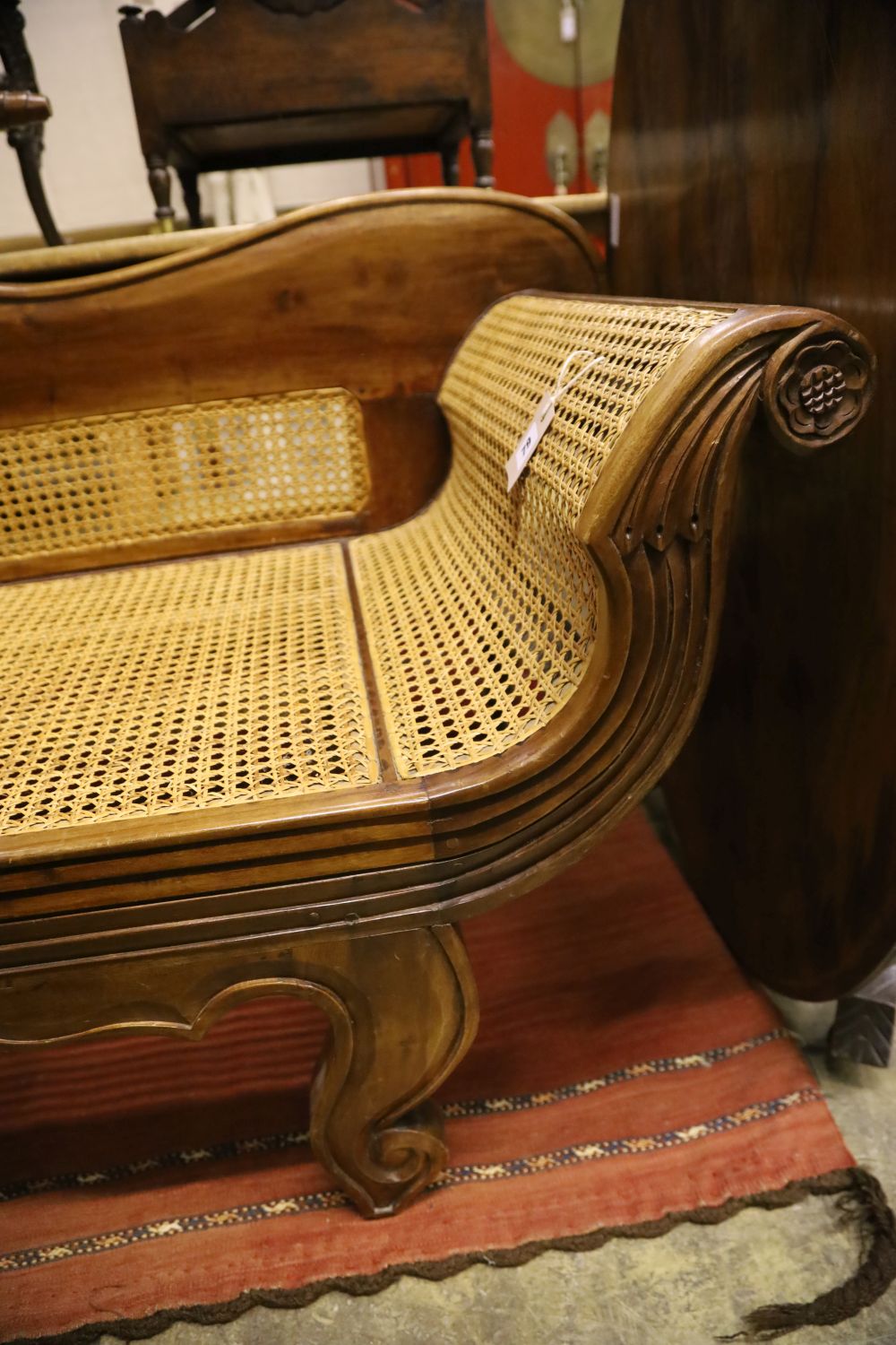 A colonial style caned hardwood scroll end settee, length 186cm, depth 62cm, maximum height 90cm
